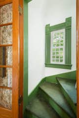Green trim and carpet add a playful splash of color in one of the staircases connecting the floors.
