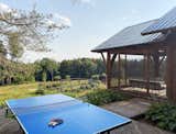 A wooden deck, complete with a ping pong table, offers another outdoor area for gathering.&nbsp;