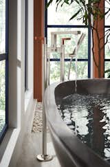 Bath Room and Freestanding Tub The collection’s wood details add warmth and texture to cool surfaces and “make for a welcoming, naturalistic palette,” says Lord.  Photo 4 of 8 in Brizo’s New Collection Is a Stylish Nod to Frank Lloyd Wright
