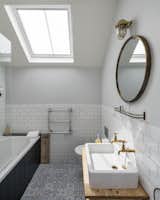 Lined with elaborate tilework, the primary bathroom also boasts an oversized soaking tub.
