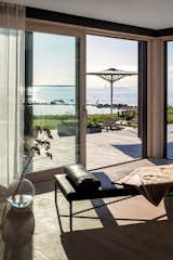 The home’s interior opens directly to a large deck and the sea beyond.