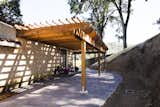 Natural redwood pergolas provide shady places to linger at Jeriko Estate and Resort in Hopland, California. "Redwood has a way of dissolving boundaries between garden rooms and their picturesque surroundings," says Hewitt.