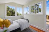 A second, smaller bedroom on the top floor boasts an attached deck with impressive vistas.