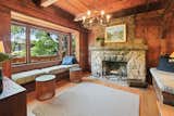 An original stone fireplace awaits in the living room adjacent to the foyer. Built-in benches offer plenty of plush seating for residents and guests.
