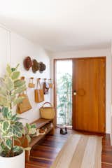 A well-organized entryway leads to a living room that opens to gardens on two sides.