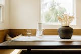 Bathed in natural light, the kitchen’s built-in eating nook is the perfect spot to linger over breakfast. The LifeStraw Home water filter’s simple, sleek design suits the home’s pared-back aesthetic.  Photo 7 of 10 in A Couple Bring Scandinavian Simplicity to a Complicated Renovation in L.A.