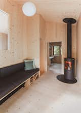 Living, Corner, Sofa, Light Hardwood, Pendant, and Wood Burning  Living Corner Wood Burning Photos from This Spruce Cabin in Switzerland Is Like a Grown-Up Tree House