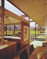 The glass doors of the dining area lead to a covered walkway that connects with the poolside patio. As in other parts of the house, the orientation of the ceiling boards alternates with each bay.  Photo 8 of 11 in Travel Back in Time to William F. Cody’s Now-Razed Desert Modern