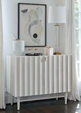 The Vienna chest has midcentury-modern flair and plenty of storage space for entertaining requisites, such as this shapely wine cooler made of Carrara marble. The intriguing artwork—a print by San Francisco–based artist Rob Delamater titled Modern Forms II—provides the perfect icebreaker.&nbsp;