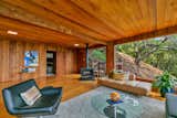 A freestanding fireplace in the living room sits just steps from the primary sleeping area.  Photo 7 of 17 in A Midcentury-Modern Home With Floor-to-Ceiling Windows Seeks $1.4M in Berkeley, CA