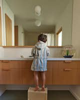 The couple kept materials simple in the kids’ bathroom—where Felix gets a step up—pairing Caesarstone with tile from Daltile.