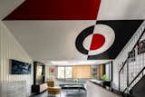 The architect collaborated with local craftspeople to re-create Reichert’s black-and-red graphics on the facade and living room ceiling. The walnut flooring is from Cascade Pacific Flooring and the Stiletto LED pendant by Sonneman.  Photo 3 of 4 in A Seattle Couple’s Playful Home Honors the Eccentric Vision of Its Original Architect