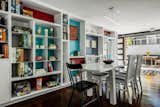 For the dining area, Hampden designed a bookcase to store the clients’ extensive board game collection and installed sliding doors to connect the space to a new patio.  Photo 2 of 4 in A Seattle Couple’s Playful Home Honors the Eccentric Vision of Its Original Architect