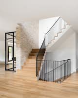Precise millwork off-sets the graphic appeal of the home’s black stair railings and window frames.&nbsp;