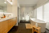 The primary suite’s soothing bathroom space features a deep soaking tub.
