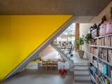 Kids Room Structural concrete walls define the form of the interior spaces, but the architects wanted to add some vibrancy to the home. An angular staircase is painted bright yellow to make a visual impact.  Photo 4 of 7 in A Multigenerational Home in Amsterdam Can Be Reconfigured for Changing Demands