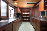 The redwood-clad kitchen features glazed-tile floors and updated appliances.  Photo 8 of 22 in A Redwood-Clad Midcentury With an In-Law Unit Lists for $1.75M in Berkeley, California