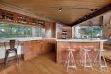 A large kitchen island and separate bar counter provide ample seating.