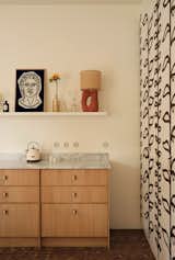 The kitchen walls are adorned with a freehand pattern rendered by Madani.