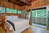 Upstairs, the principal bedroom connects to a private patio that overlooks the backyard.  Photo 8 of 10 in A Harry Bates–Designed Home Is Available to Rent in East Hampton