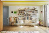 Playful pops of color are sprinkled throughout the two floors, including stripes of yellow running across the ceiling in the children’s room.