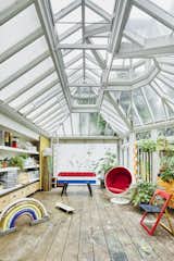 Adjoining the kitchen is the large conservatory space, where glazed doors open to a garden. "I think it’s perfect for entertaining," says Eric. "People come in and have drinks in the kitchen, then we move to eat dinner in the conservatory."
