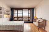 Floor-to-ceiling windows help bathe the bedroom in natural light.