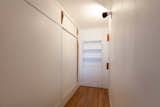 Original built-in storage lines the hallway that leads to the bathroom.  Photo 9 of 10 in A Restored Duplex Apartment in Le Corbusier’s Iconic Cité Radieuse Seeks $437K