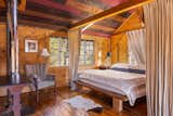 A vaulted ceiling in one of the bedrooms is clad in wood panels with different hues. In total, the two-level barn can comfortably accommodate six to eight people.