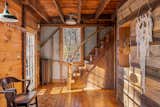 A handcrafted staircase leads to the lofted sleeping areas on the barn’s upper level.