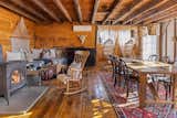 A large Vermont Castings woodstove anchors the open-plan living and dining area in the converted barn.