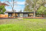 A newly landscaped and generous-sized lawn awaits in the backyard.  Photo 13 of 13 in A Restored Midcentury Wrapped Around a Reflecting Pool Lists for $1.39M in Sacramento, CA