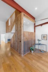 A closer look at the staircase, highlighting the floor's grand sense of space.  Photo 7 of 11 in A Former Garage, Now a Light-Filled Residence, Lists for $625K in Philadelphia