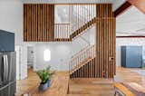 The team at C2 Architecture designed the new staircase from reclaimed wood slats.
