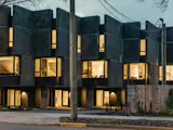 The cantilevered upper floors create a covered courtyard for each unit. Some of the facade’s stucco panels protrude to provide privacy and shade. Many of the principals at Goodman’s company, Aryze, have young children, as does Jones, making the team well suited to design for growing families’ needs. “We don’t find it hard to relate to stuff like this,” says Jones.