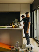 Michael and <span style="font-family: Theinhardt, -apple-system, BlinkMacSystemFont, &quot;Segoe UI&quot;, Roboto, Oxygen-Sans, Ubuntu, Cantarell, &quot;Helvetica Neue&quot;, sans-serif;">Nathan in their home's kitchen.</span>  Photo 5 of 15 in A Group of Brutalist Townhomes Brings a Bit of Relief to a Canadian City’s Overheated Housing Market