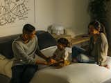 Michael sits with his partner, Aiko Lista, and Nathan in the couple's bedroom.