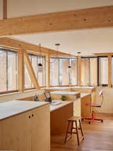 Built-in desks and cabinets by Égoïne create an office nook overlooking the staircase.