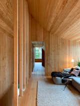 The interior walls, ceilings, and built-ins are clad in Siberian larch from UPK Concept.&nbsp;Tham placed the glazed openings and doorways to maintain clear sight lines throughout the long and narrow home.&nbsp;