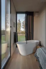 Wood features prominently in the home’s design—from the cross-laminated timber walls and oak floorboards to the pine deck, which Maris built.