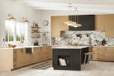 A kitchen with Ormandy pendants and a Blair faucet are in aged brass.