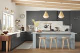 A kitchen with Blair pendants, Blair shelving, Blair cabinet hardware, and Blair faucets from Rejuvenation.