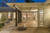 The current homeowner added a fire pit and moody lighting to the yard.  Photo 16 of 18 in A Signature Midcentury Modern by Architect Ralph Haver Seeks $1.1M in Phoenix