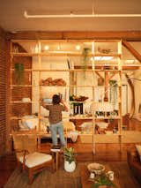 Bronte frequently restyles the shelves, which serve triple duty as storage, a display for special decor items, and a divider between the living room and bedroom.