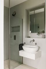 An en suite bathroom has a walk-in shower and Italian fixtures by Falper.