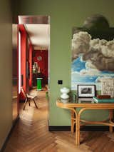 Hugo chose a deep-red paint color for the main living area and a pale-green hue for the bedroom. Sections of the walls in the living room and bedroom are covered with an aluminum veneer.  Photo 3 of 7 in A Designer’s Small but Sumptuous Apartment Lists for €410K in Paris