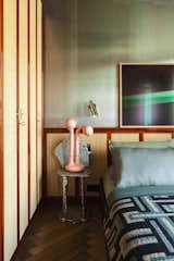 Bedroom The Alualéatoure chair by Hélène de Saint Lager serves as a nightstand with a pink ceramic lamp by Entler Studio.  Photo 5 of 7 in A Designer’s Small but Sumptuous Apartment Lists for €410K in Paris