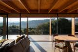 A couch from Lider Interiores and a Cremme table anchor the wide-open living/dining area. The dining chairs are by Fernando Jaeger.