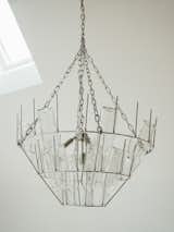 Bought for their first Berlin apartment, Elena and Roland’s chandelier from TK Lighting incorporates a rack with clear bottles for dispersing light. The ceilings of the Steins’ current apartment are too low to accommodate it, so the fixture was in storage until it was installed in the Seeland house’s double-height kitchen.