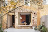 A pitched-timber pergola that integrates interior and exterior is the defining feature of a kitchen extension by Benjamin Wilkes for the circa 1908 home where James and Kate Greenfield live with their two children in South London. The Tigra Multi brick is from Traditional Brick and Stone.